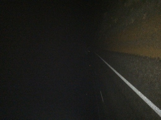 A dark night view of Great Eastern Highway from the road shoulder