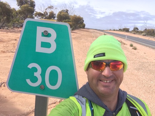 Gary beside a B30 road marker on the Eyre Highway
