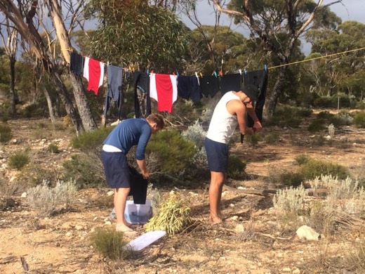 Ben and Ols hand washing clothes after Balladonia Roadhouse had no laundry facilities
