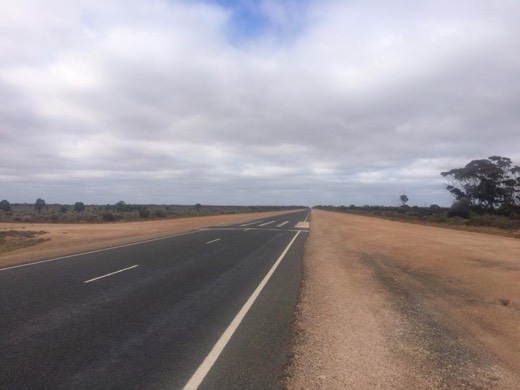 The Eyre Highway stretching ahead on the RFDS emergency airstrip section.