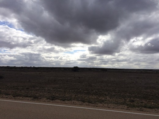 Dark cloud over open Nullarbor country beside the Eyre Highway