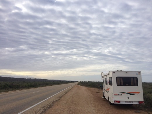 The Hearts Across Australia campervan stopped beside the Eyre Highway under a rippled sky