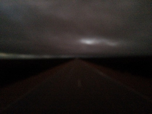 Dark early-morning view through the windscreen on the Eyre Highway in South Australia