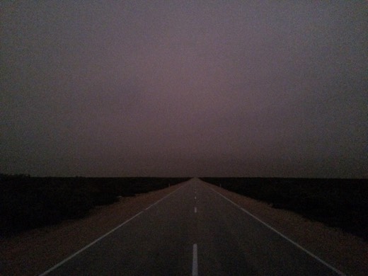 The Eyre Highway disappearing into a dim dawn on Gary's first full day in South Australia