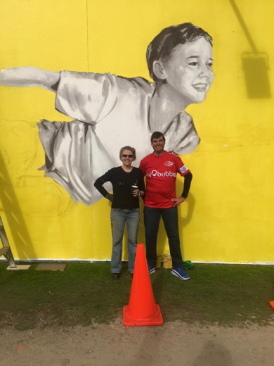 Gary with Yvonne in front of the flying-boy mural of her son Austen.
