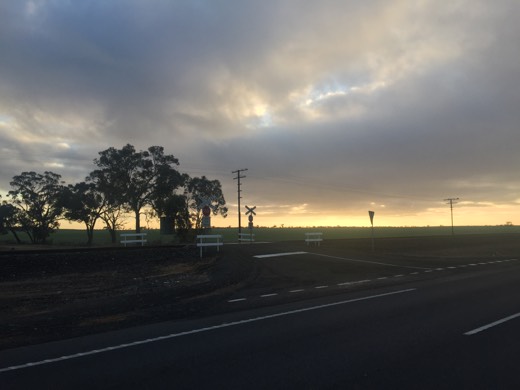 Low cloud and morning light over a railway crossing during Day 73