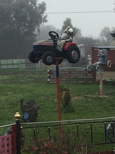 A strange roadside display in Horsham with a small vehicle mounted high above the garden