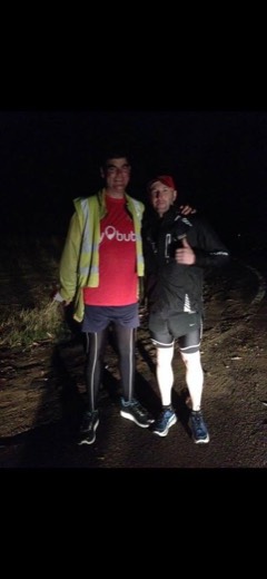 Gary and Bob Sheldon standing together beside the route after dark.