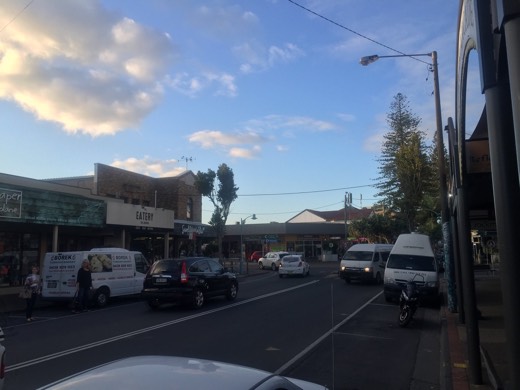 Shops and traffic on a Byron Bay street.
