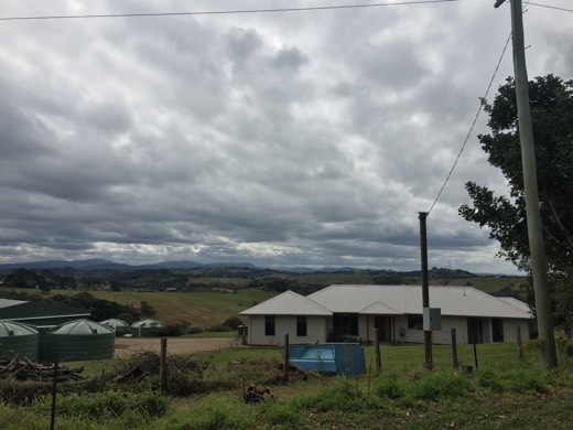 Clouds over the hills and houses approaching Byron Bay.