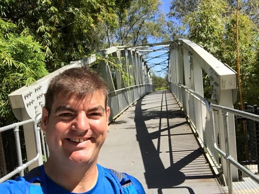 Gary on a pedestrian bridge during a walk near Jindalee.