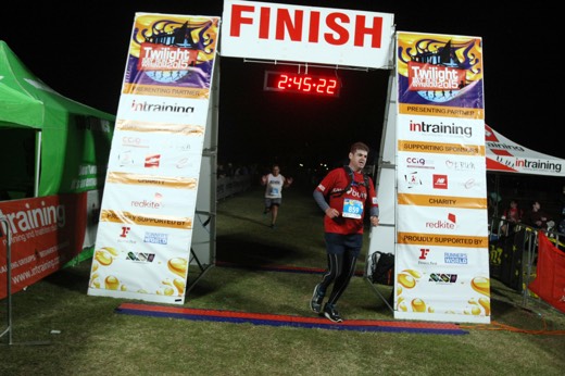 Gary crossing the Twilight Bay Run finish line with David Ryan behind him.