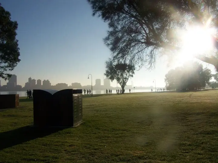 Gary running beside the Swan River during the 2013 Perth Marathon with Perth city in the background
