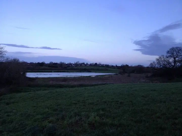 A wide flooded field under a winter sky on the old school cross-country route