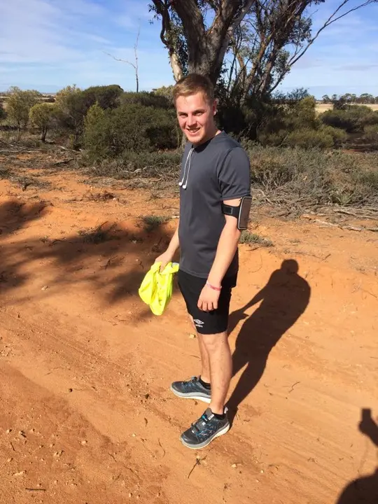 Ben Sutton out walking and running a support section on red dirt beside the route