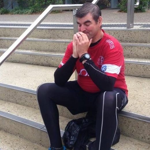 Gary seated on the steps at South Bank after reaching the parkrun start area in Brisbane.